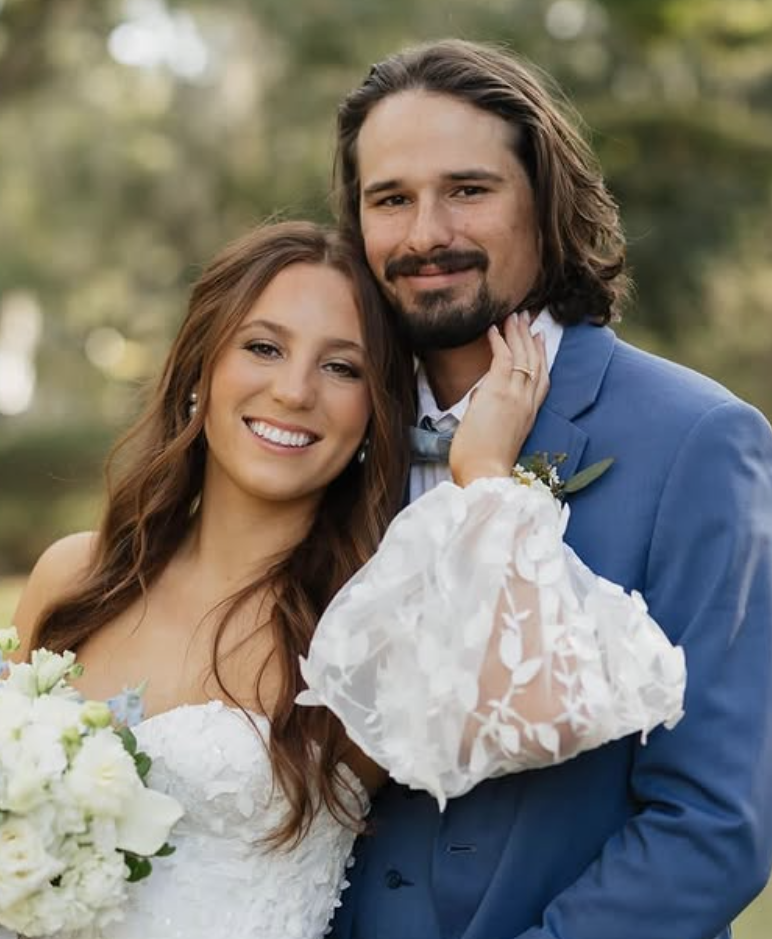 Bride with long blonde waves in lace robe